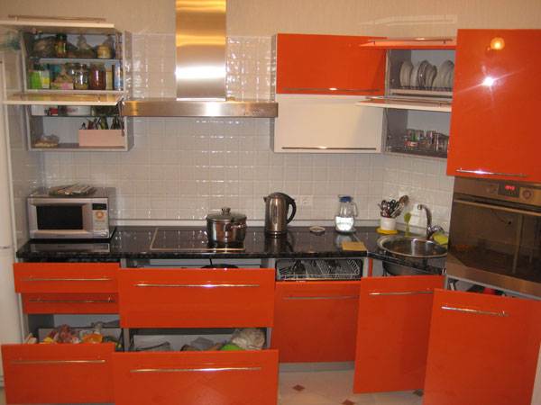 Вместительная угловая кухня с бело-оранжевыми фасадами