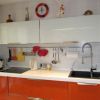 Оранжево-белая кухня 10 кв.м с гостиной (23 фото)